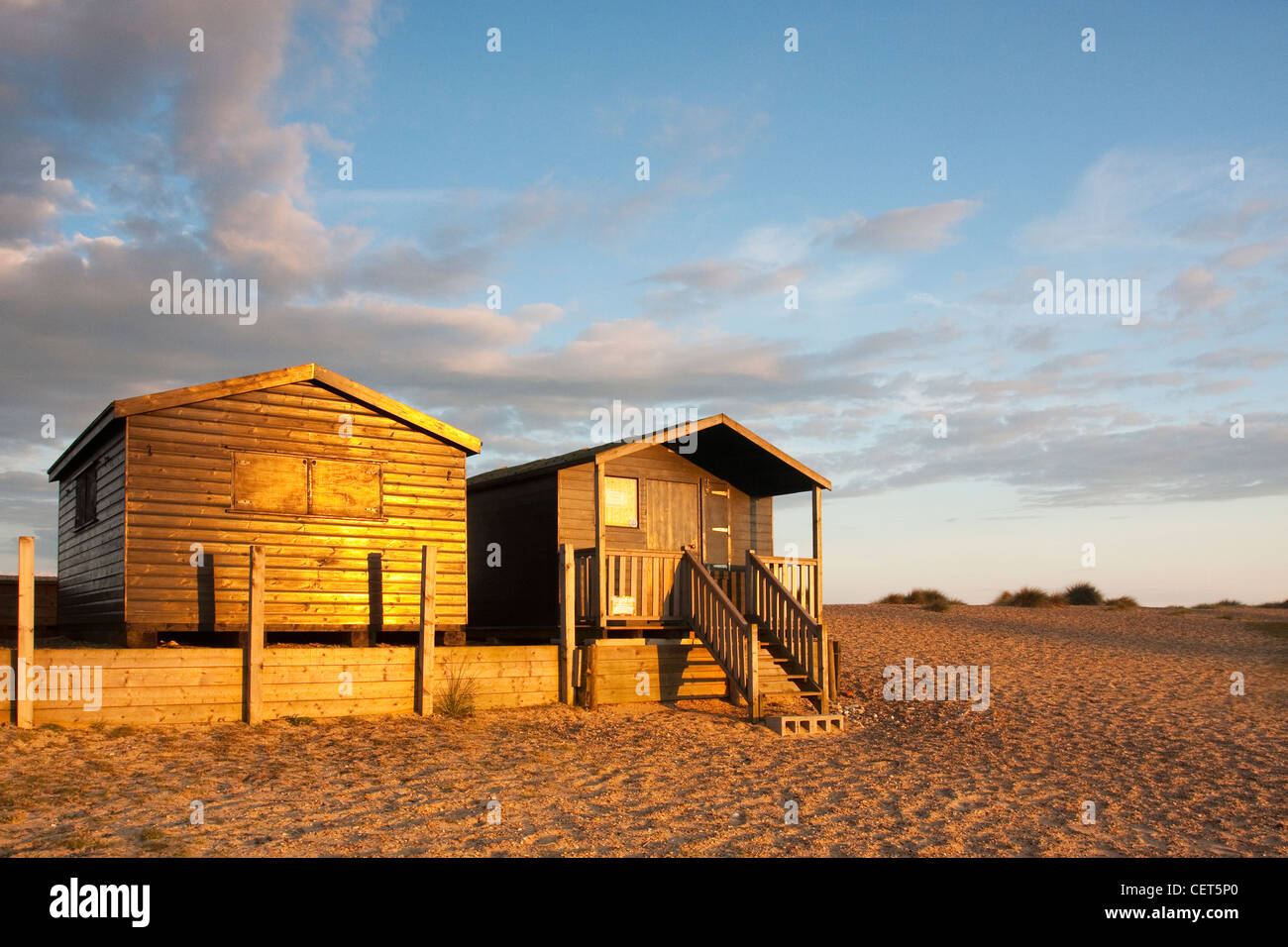 Last light illuminating beach huts at Walberswick on the Suffolk Coast. Stock Photo