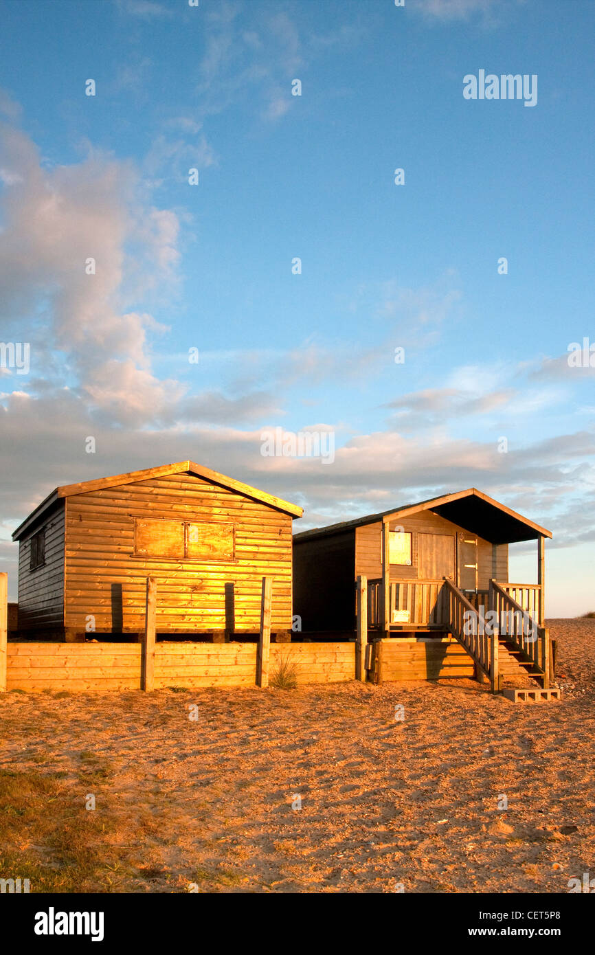 Last light illuminating beach huts at Walberswick on the Suffolk Coast. Stock Photo
