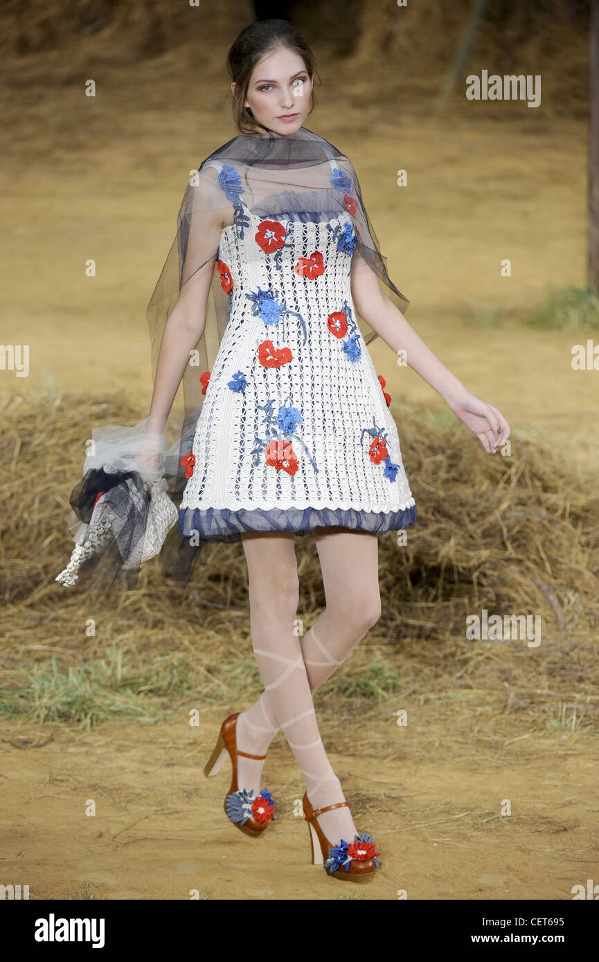 Chanel Paris Ready to Wear Spring Summer A white crocheted sleeveless dress  red and blue applique fabric flowers over it, a Stock Photo - Alamy