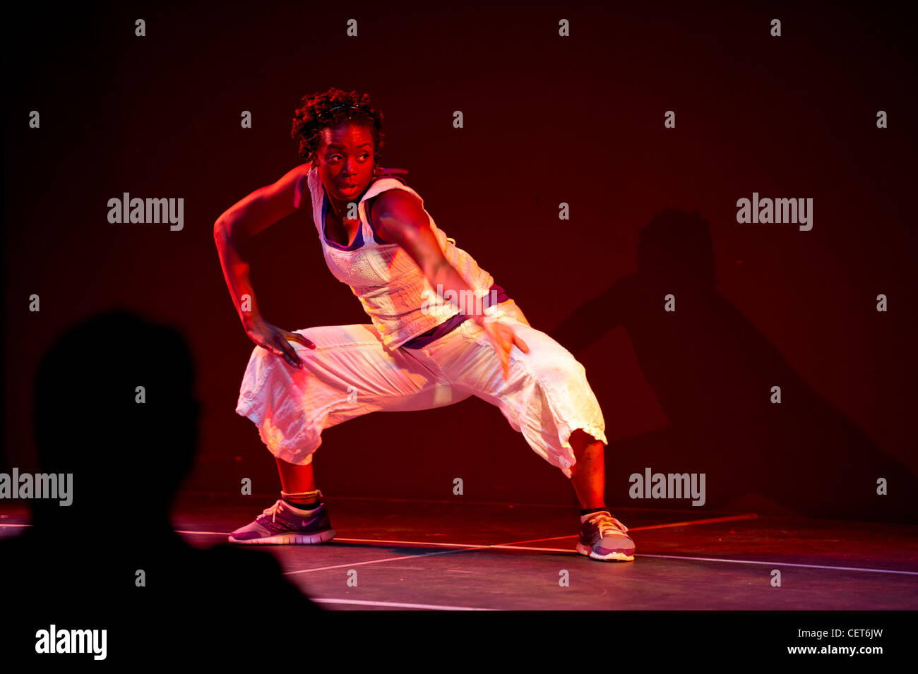 Girl performing interpretive hip hop dance on stage Stock Photo