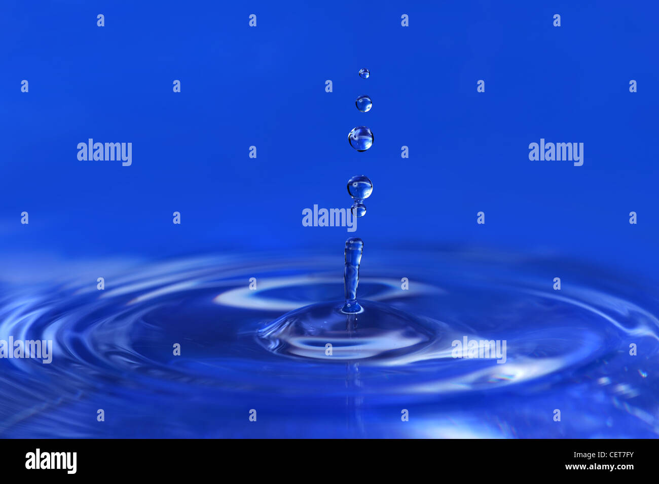 Water drops falling creating ripples Stock Photo
