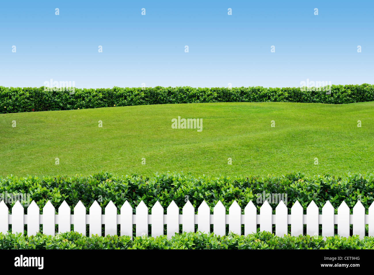 White fence with grass on clear blue sky Stock Photo - Alamy