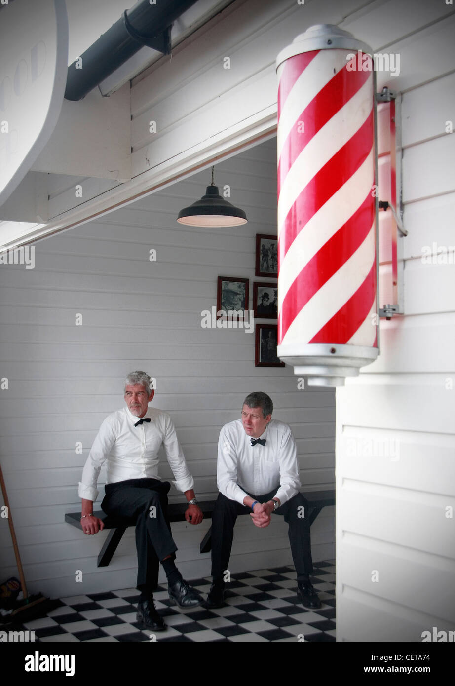 Men sitting in old fashioned barber shop at Goodwood Revival. Stock Photo