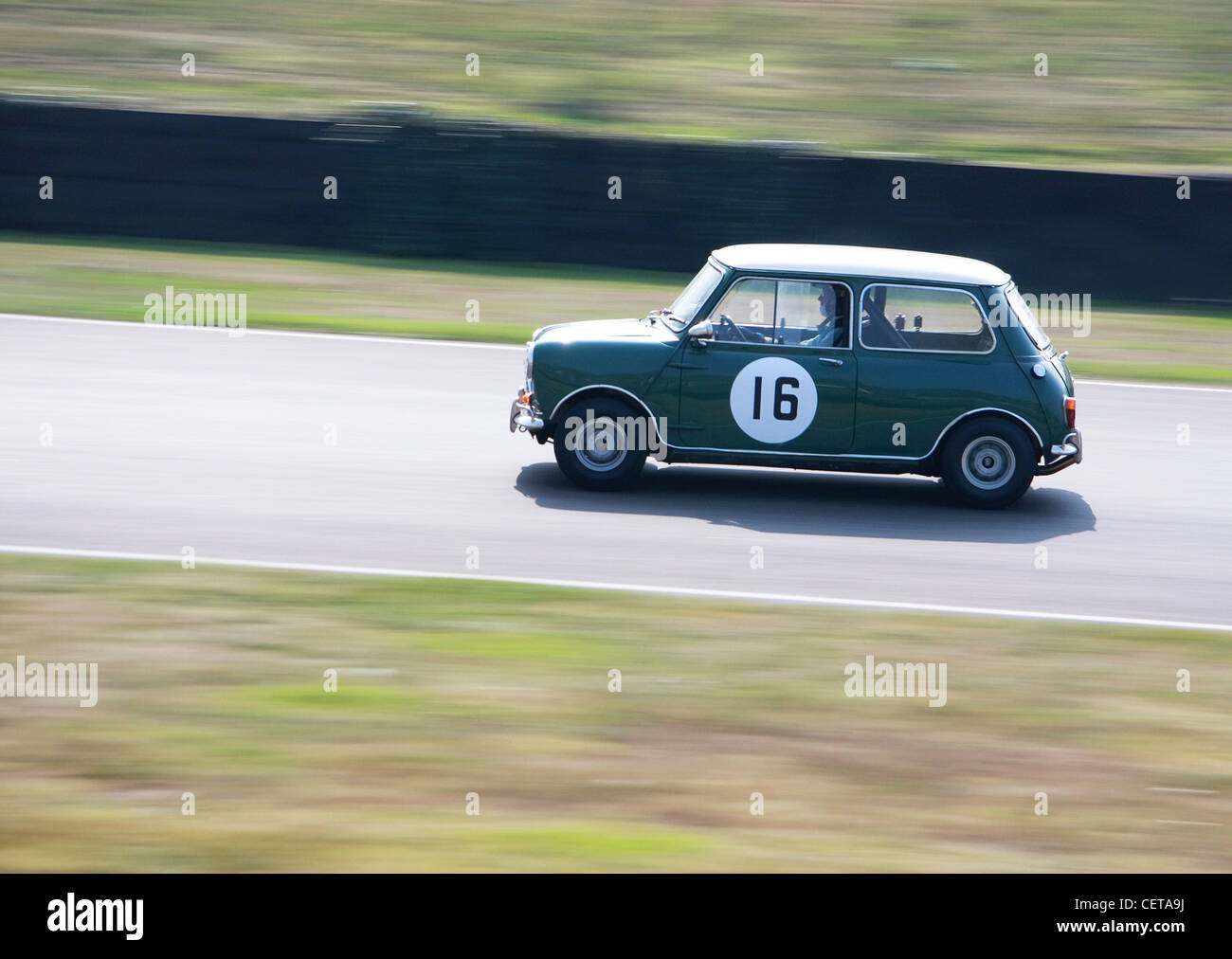 Green Mini Cooper on race track at Goodwood Revival. Stock Photo