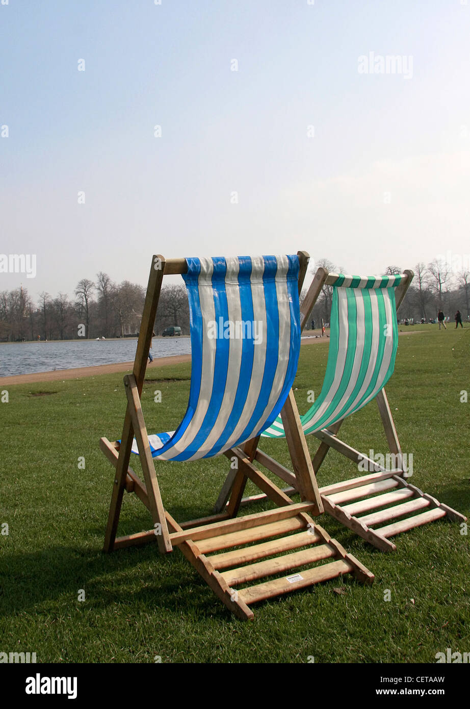 Striped deck chairs at Kensington Gardens. Stock Photo