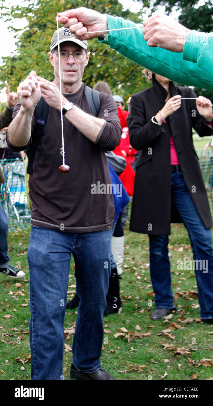 People taking part in a conkers competition. Stock Photo