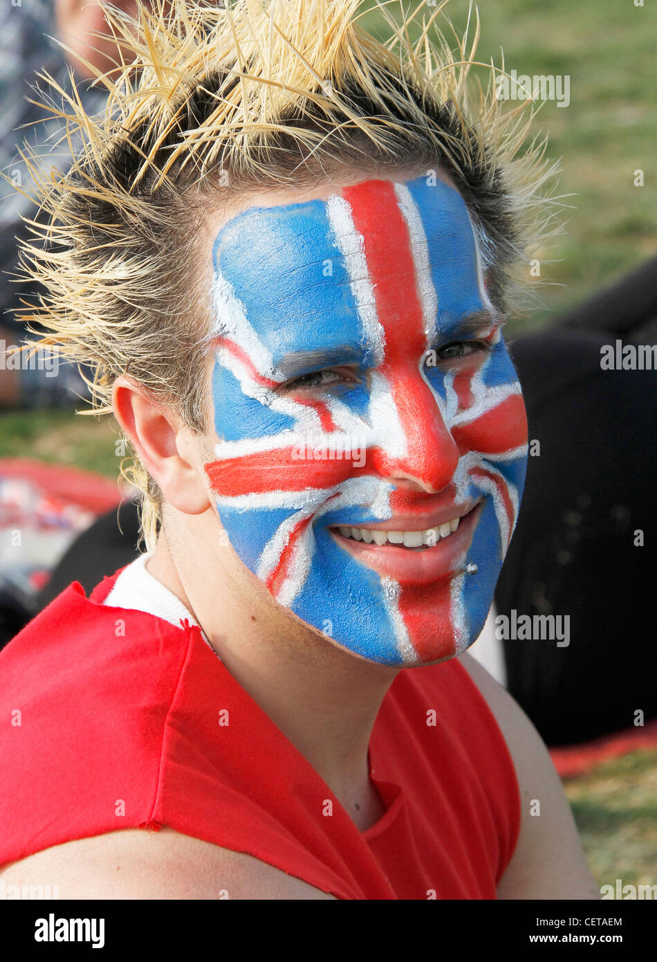 Happy young man with a union jack painted on his face. Stock Photo