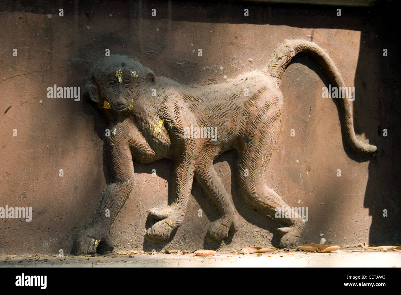 A monkey wall sculpture is part of the Wat Gate Khar Rnam Buddhist