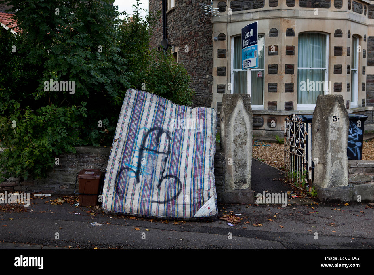 Discarded mattress outside a house in Bristol, UK Stock Photo