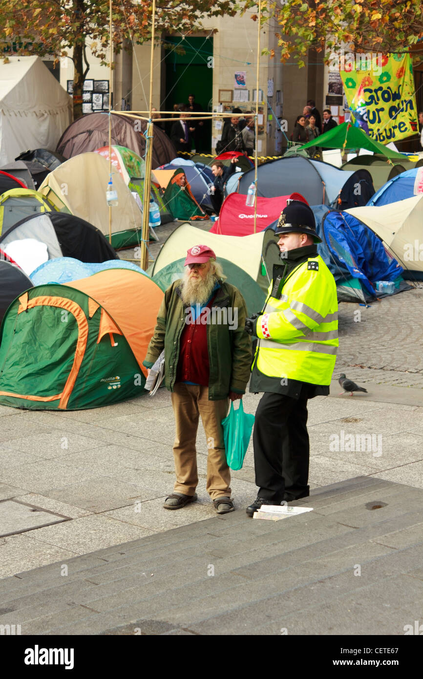 An Occupy London Stock Exchange protester talking to a policeman in front of St.Paul's Cathedral in London, UK. Stock Photo