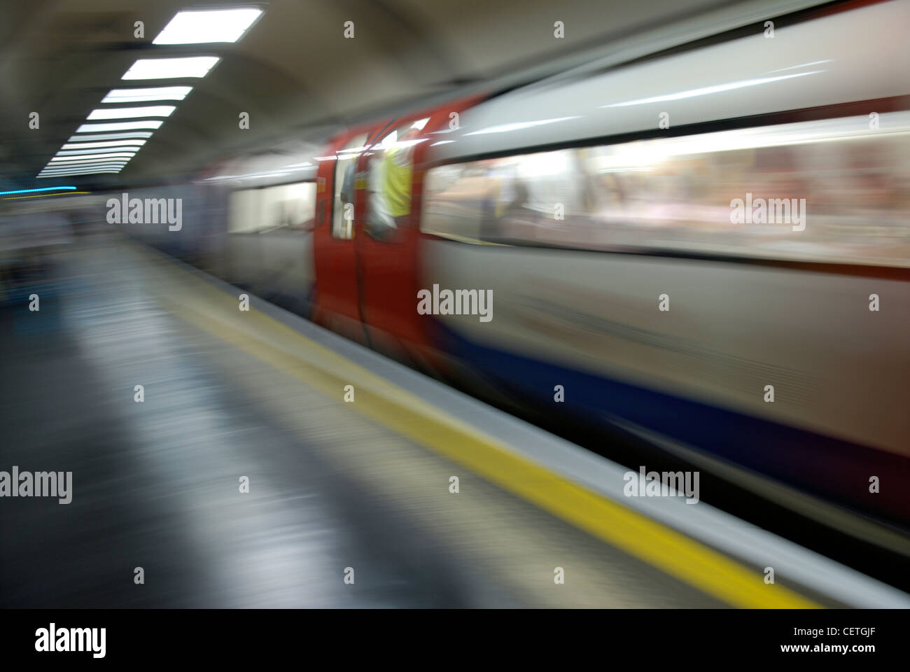 An underground train leaving the platform. Stock Photo