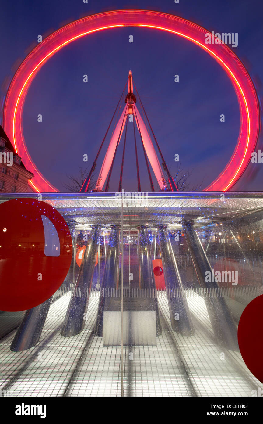 London Eye at night with Red Nose Day lighting. The London Eye can carry 800 passengers per revolution - equivalent to 11 London Stock Photo