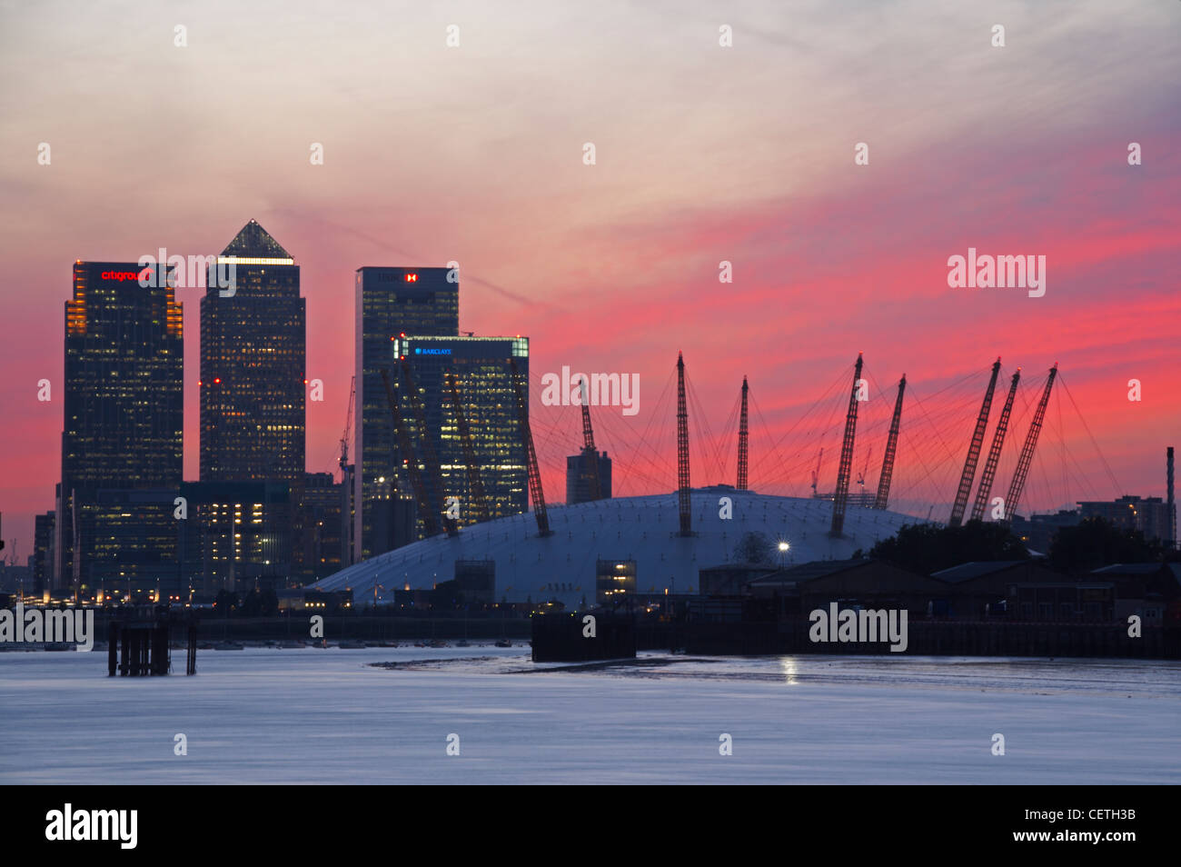 Canary Wharf and the O2 Dome at sunset. The Millennium Dome, once dubbed New Labour's white elephant, has re-opened as an entert Stock Photo
