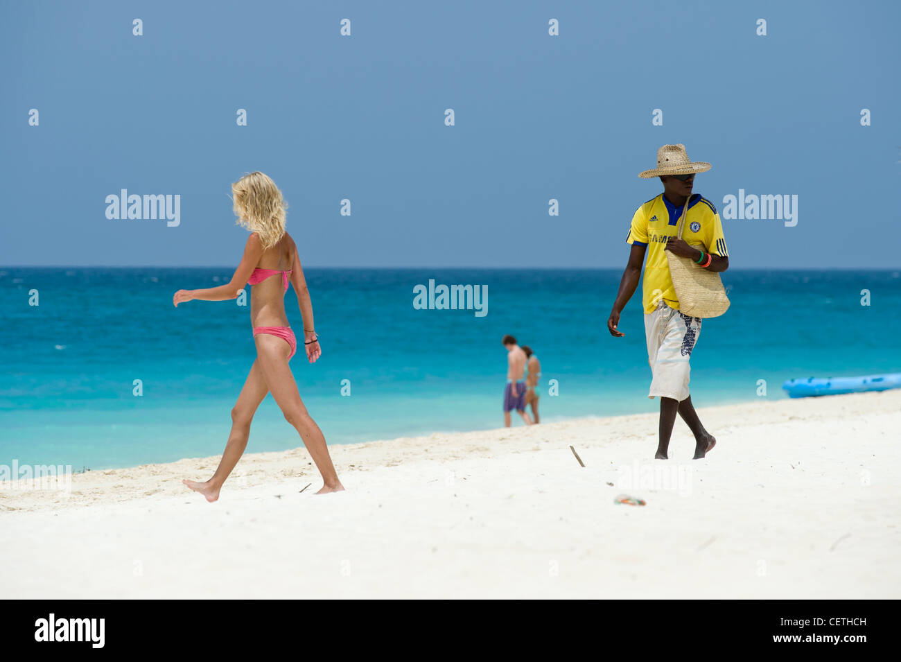Salesman and tourists on the beach of Kendwa Rocks north coast of Zanzibar Stock Photo