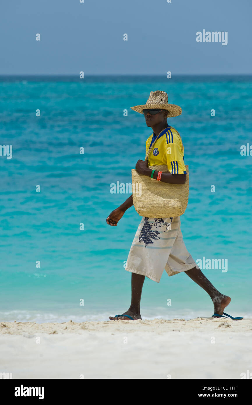 Salesman walking on the beach of Kendwa Rocks north coast of Zanzibar Stock Photo