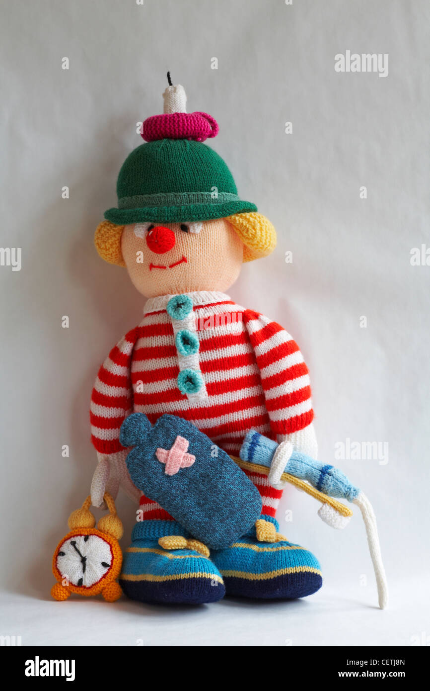 knitted doll, knitted toy - wee willie winkie with candle on head, hot water bottle, alarm clock, toothbrush, toothpaste with paste squirting Stock Photo