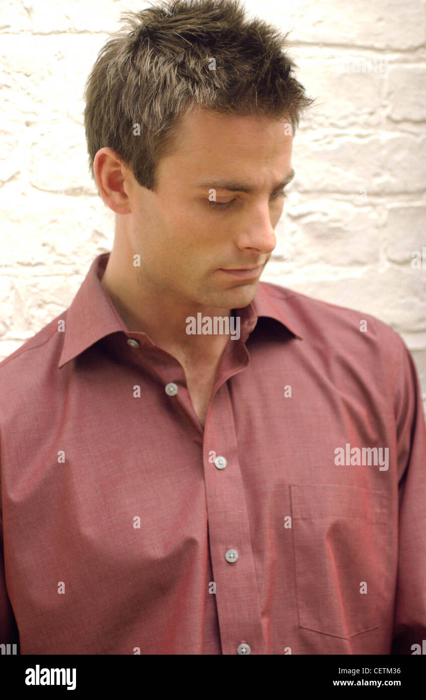 Profile Of Male With Short Brown Hair Wearing Dark Red Shirt