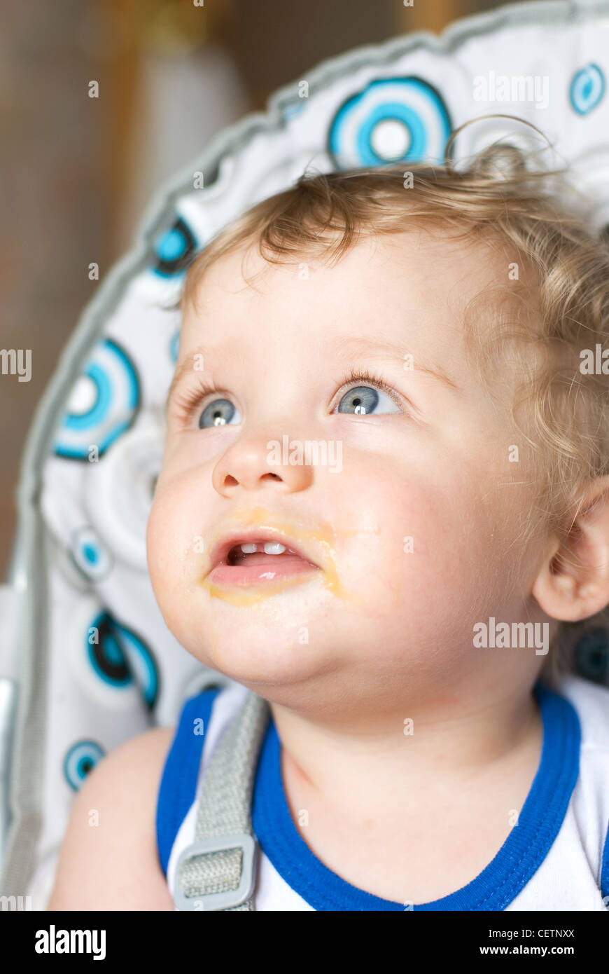 Messy smiling baby boy after eating Stock Photo