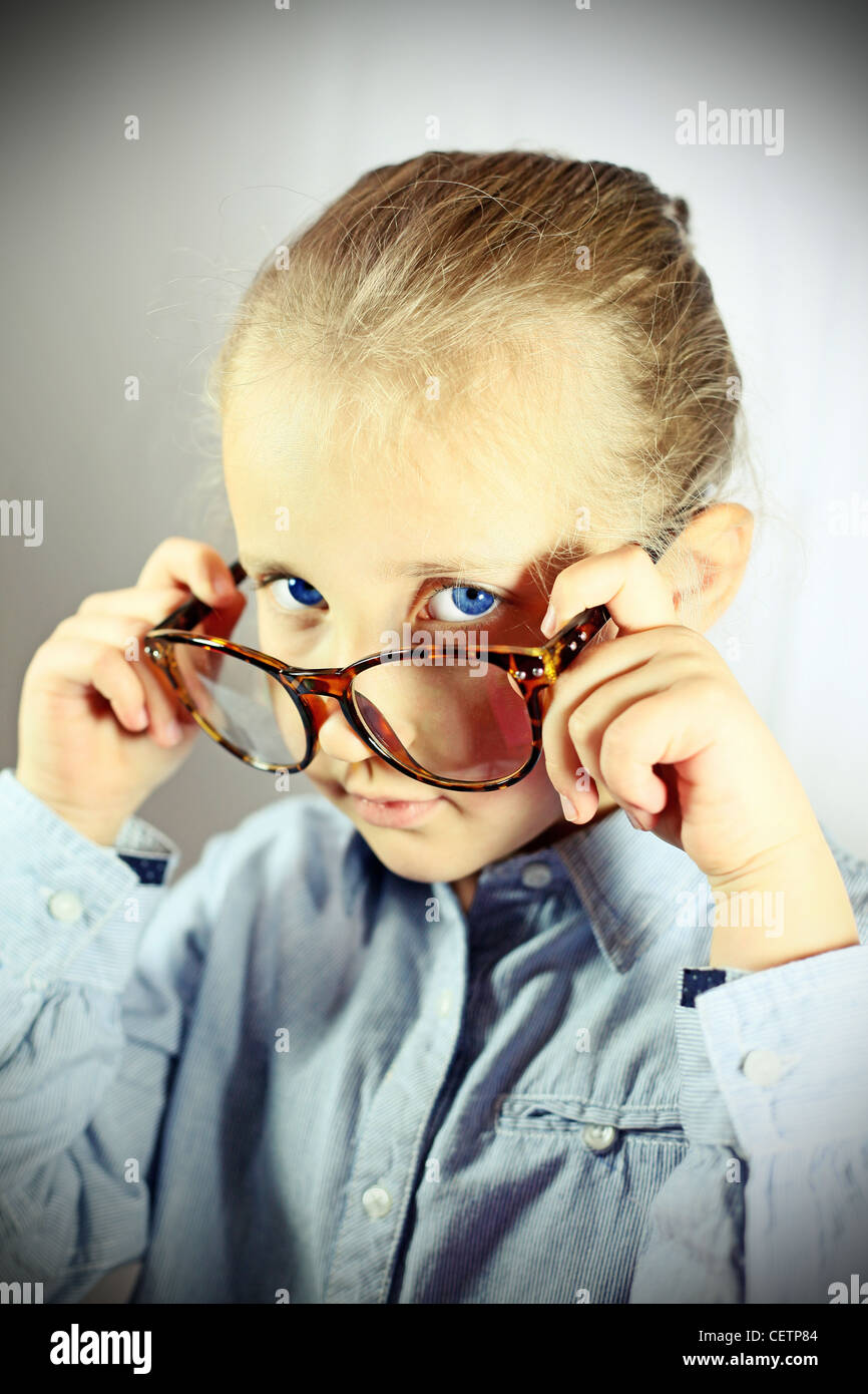 attention should be paid a schoolgirl with big glasses Stock Photo