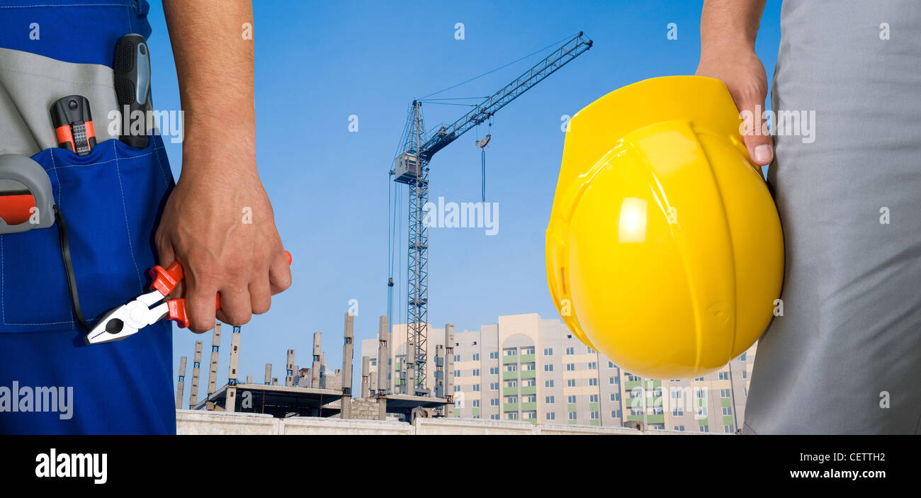 Closeup of workers with instruments on building background Stock Photo ...