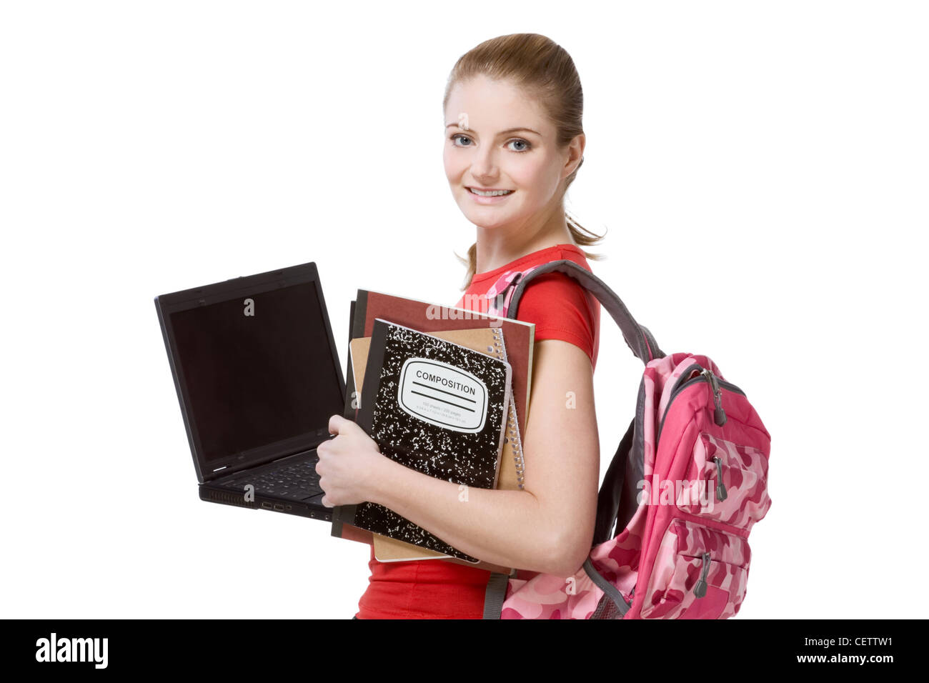 friendly Caucasian High school student schoolgirl with backpack, holding laptop computer, notebooks and composition book Stock Photo