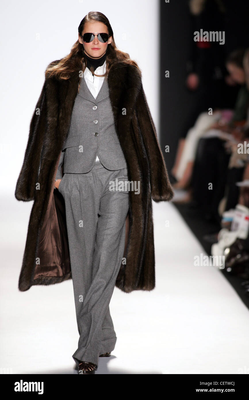 Michael Kors New York Ready to Wear Autumn Winter Estonian model Carmen  Kass in fur coat and grey trouser suit with mirrshades Stock Photo - Alamy