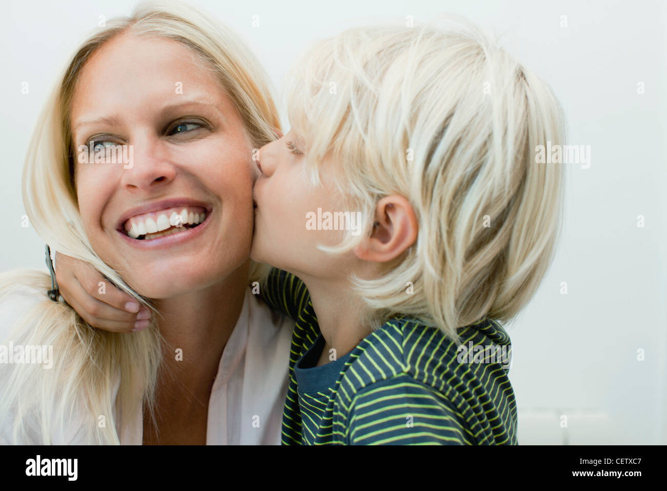 Two children kissing on the cheeks hires stock photography and images