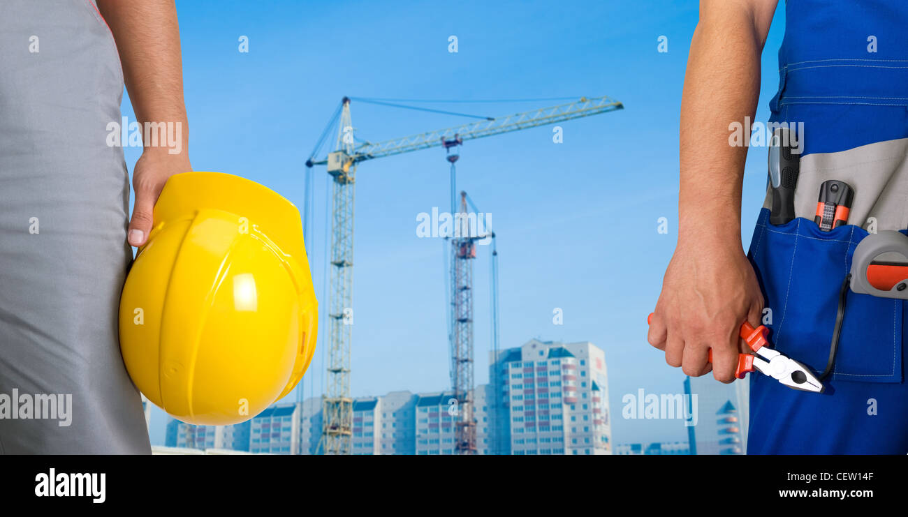 Closeup of workers with instruments on building background Stock Photo ...