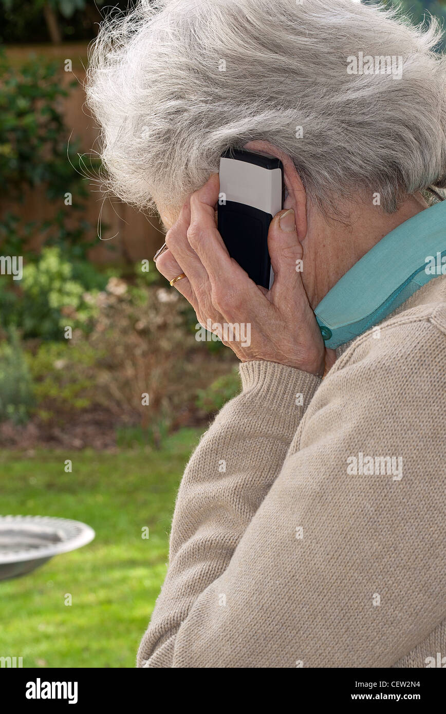 Mature Lady holding mobile phone to ear making a phone call Stock Photo