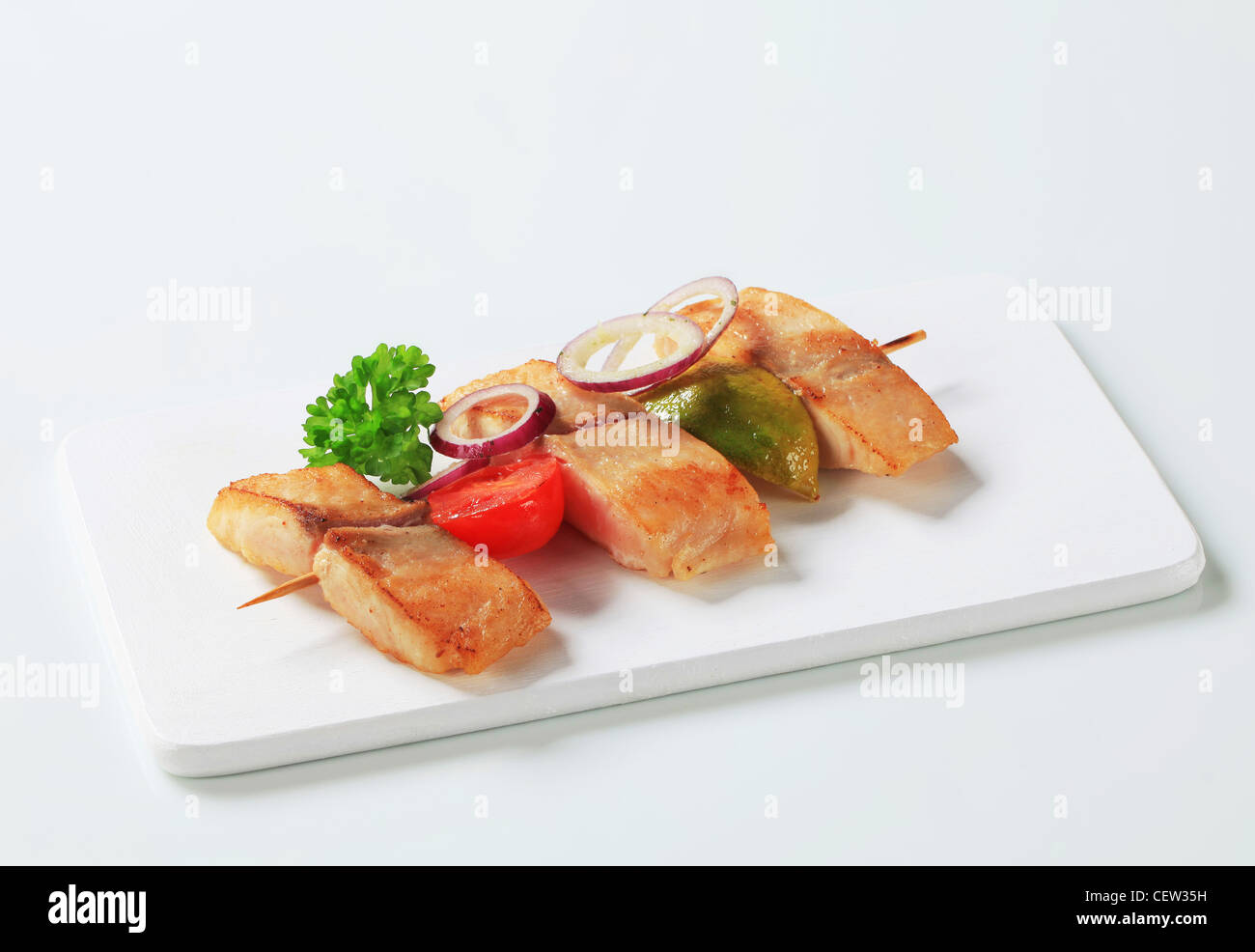 Fish skewer on cutting board Stock Photo