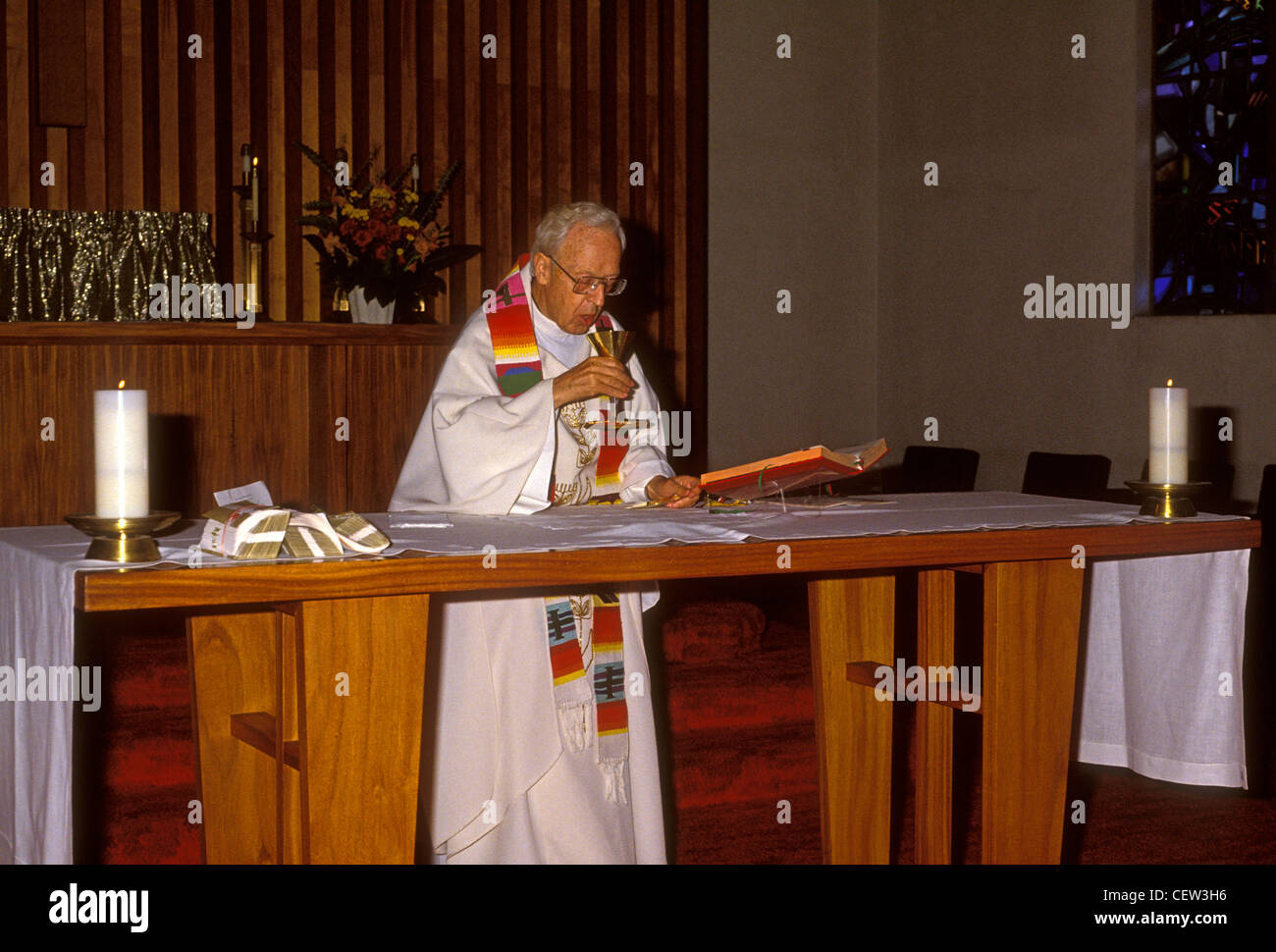 Roman Catholic priest, Elevation of the Chalice, Eucharistic Prayer, church service, mass, Novato, Marin County, California Stock Photo