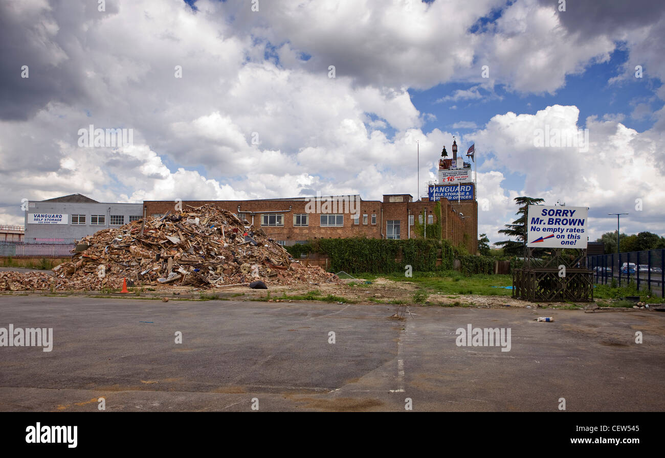 Demolished factory, with sign taunting the government and the prime minister because of avoiding building tax Stock Photo