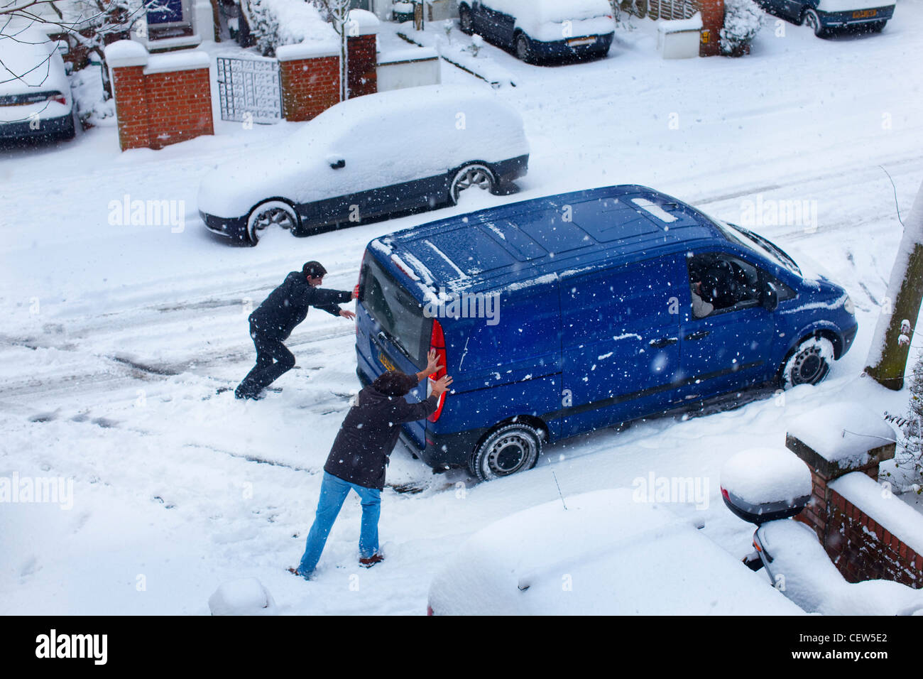 Pushing van in the snow on a London street Stock Photo