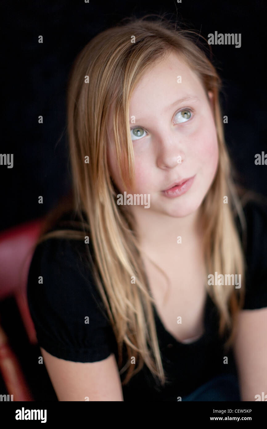 Eleven year old girl looking up, forming an idea. Stock Photo