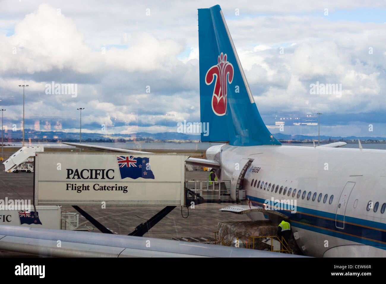 Pacific Flight Catering and detail of China Southern Airlines Airbus A330-243 in Auckland International Airport, New Zealand. Stock Photo