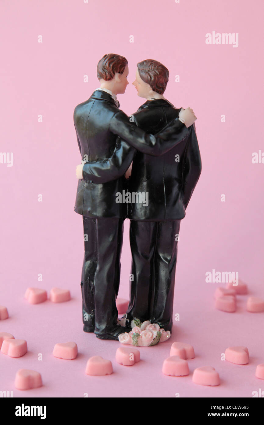 A homosexual couple against a pink background Stock Photo