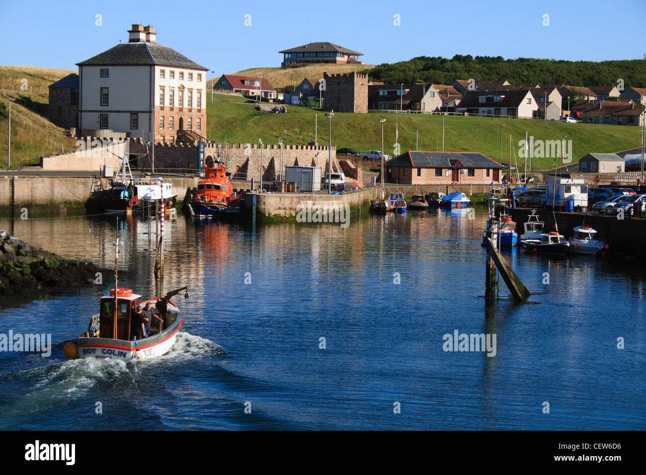 small fishing boat entering harbour Stock Photo - Alamy