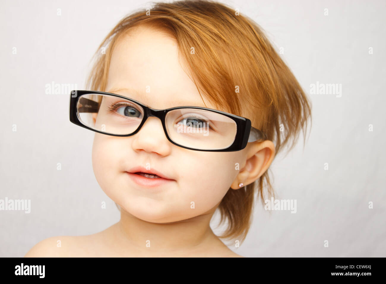 Adorable little girl with large glasses Stock Photo Alamy