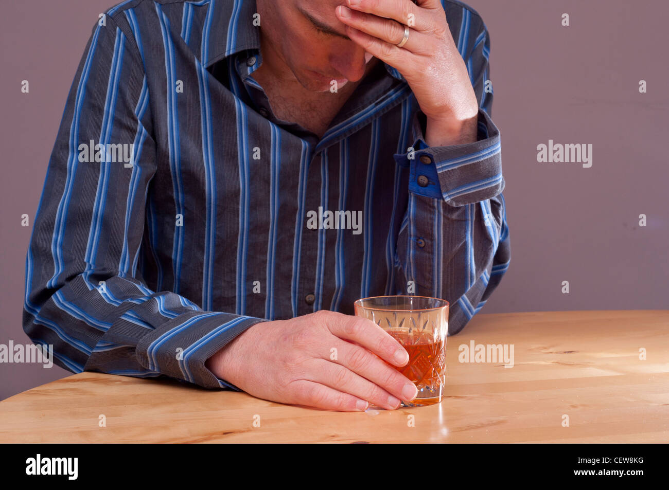 Male mental health concept. Depressed stressed man with alcohol. Stock Photo