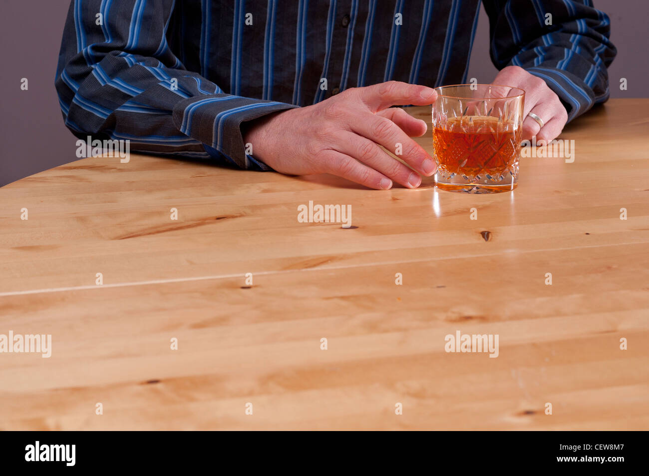 Man struggling with mental health problems and alcohol. Stock Photo