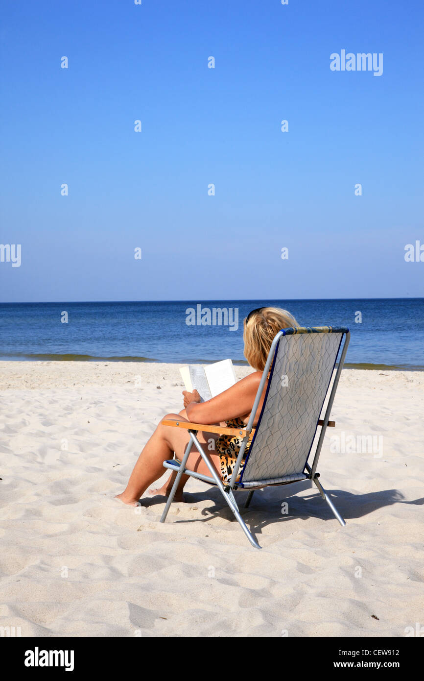 Mature woman relaxing at the beach Stock Photo