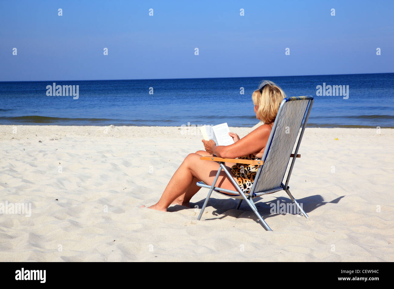 Mature woman relaxing at the beach Stock Photo