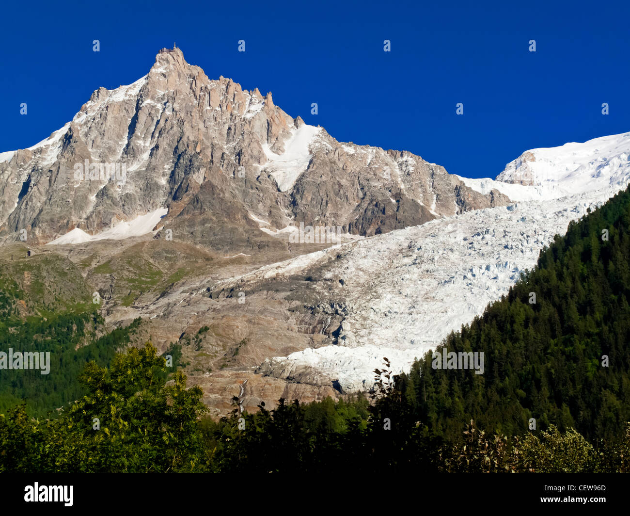 The summit of Aiguille du Midi adjacent to Mont Blanc viewed from Bossons near Chamonix in the Savoie region of the French Alps Stock Photo