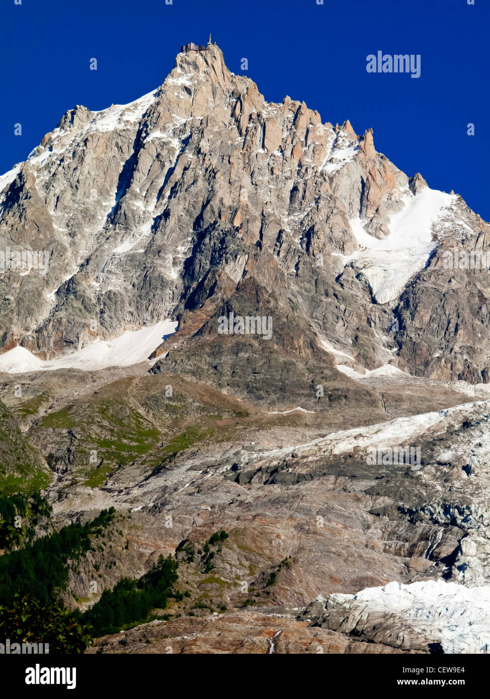 The summit of Aiguille du Midi adjacent to Mont Blanc viewed from Bossons near Chamonix in the Savoie region of the French Alps Stock Photo