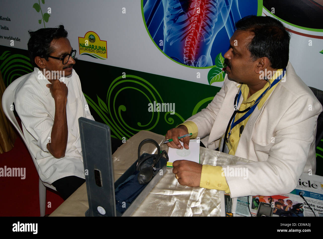 Ayurveda doctor examining his patient.Patient explaining about his problem in detail to the