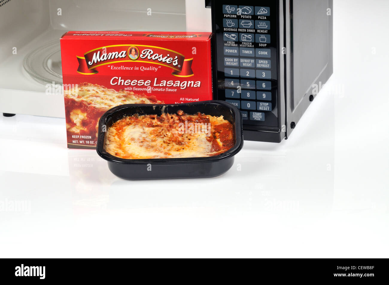 Cooked ready meal of Mama Rosie's frozen cheese lasagna dinner with microwave    open on white USA Stock Photo