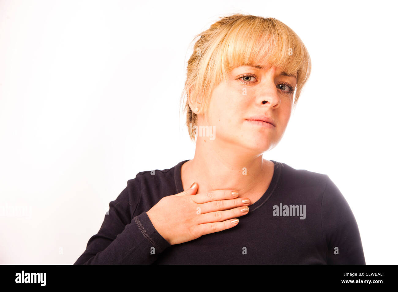 a blonde haired girl woman feeling ill unwell sick poorly sore throat Stock Photo