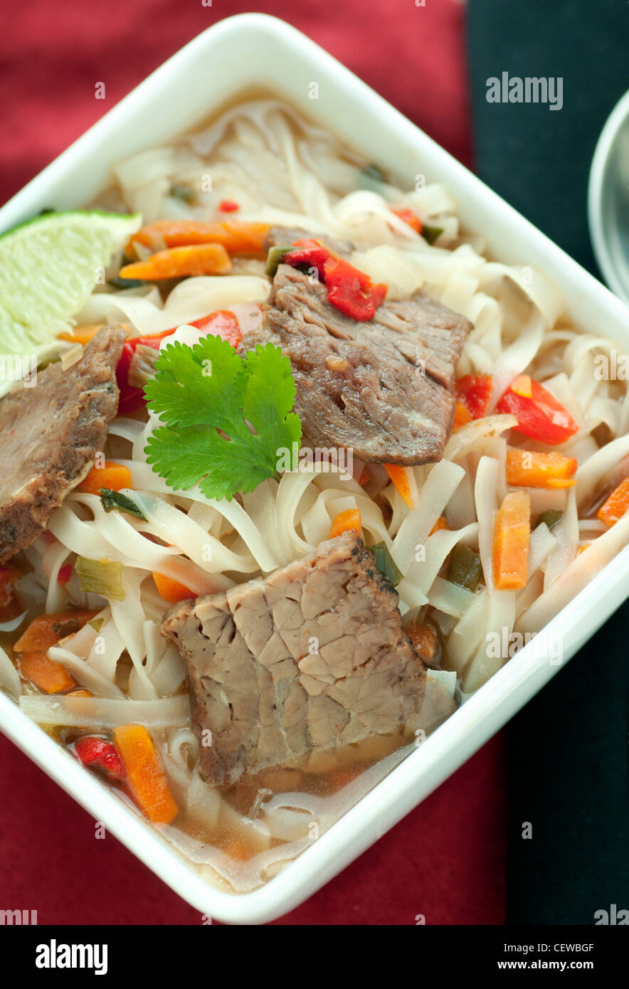 Asian beef soup with noodles and cilantro garnish Stock Photo Alamy