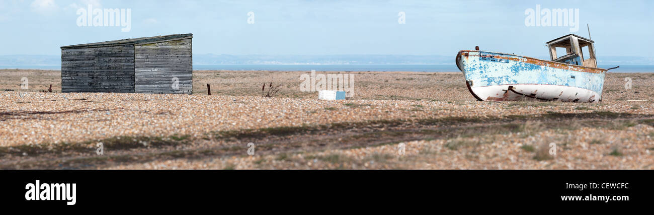 A wooden hut and an abandoned old boat on the beach at Dungeness Stock ...