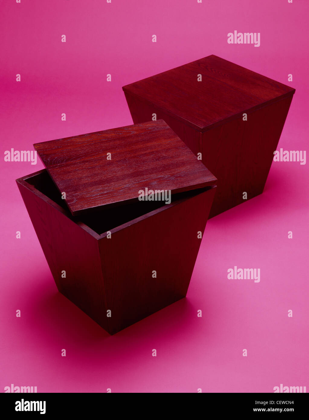 Two household furniture storage tables together on a bright pink ...